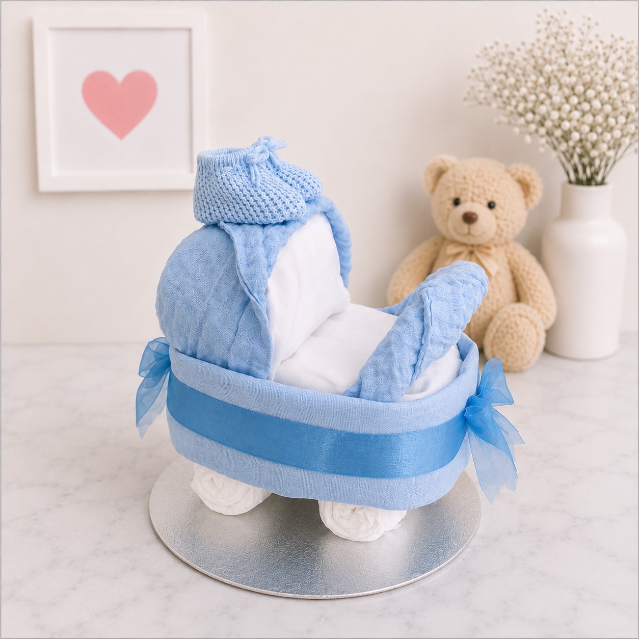 Side view of the blue pram nappy creation showing the nappy wheels and blue detailing
