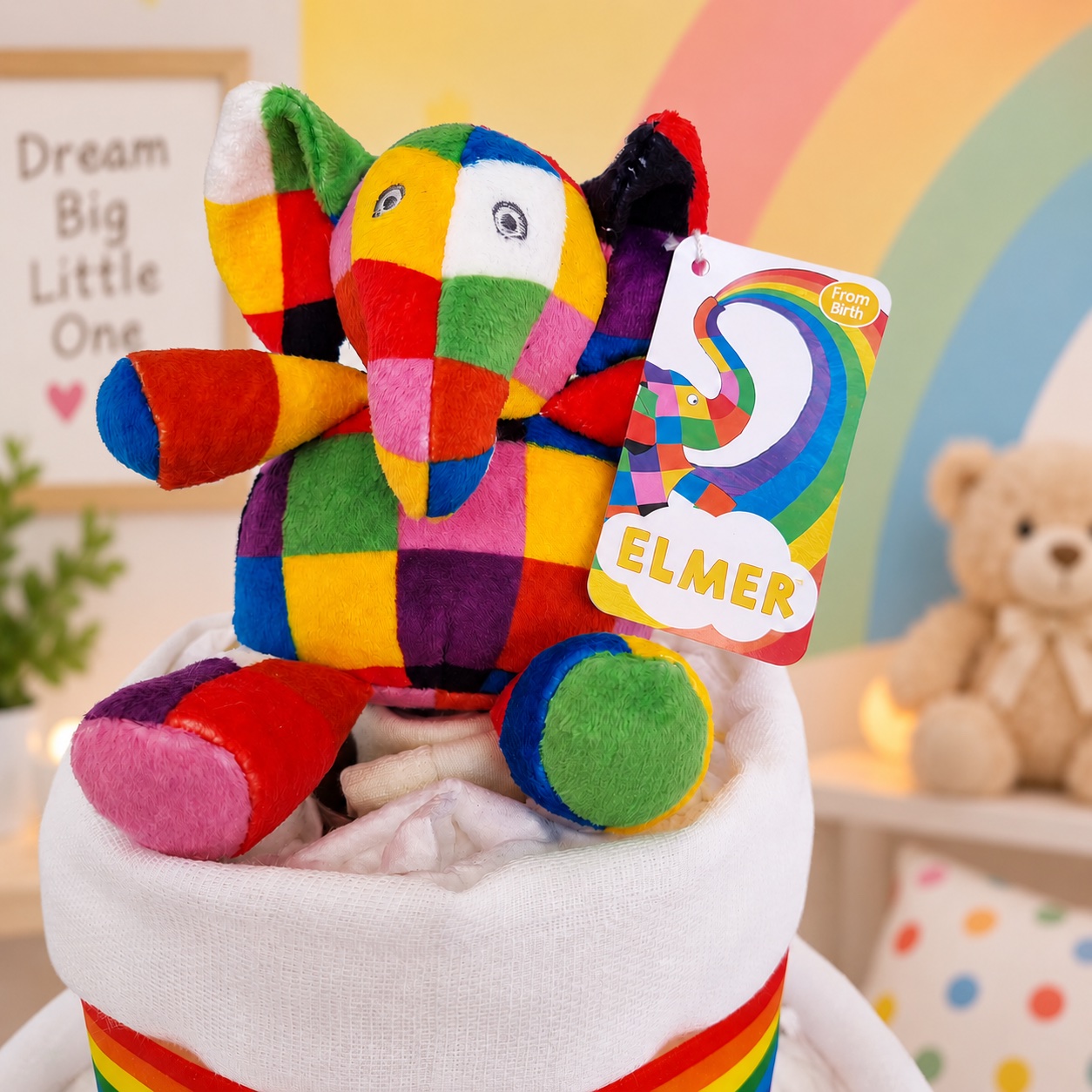 Close-up of the colourful Elmer the Elephant soft toy topper on the rainbow nappy cake