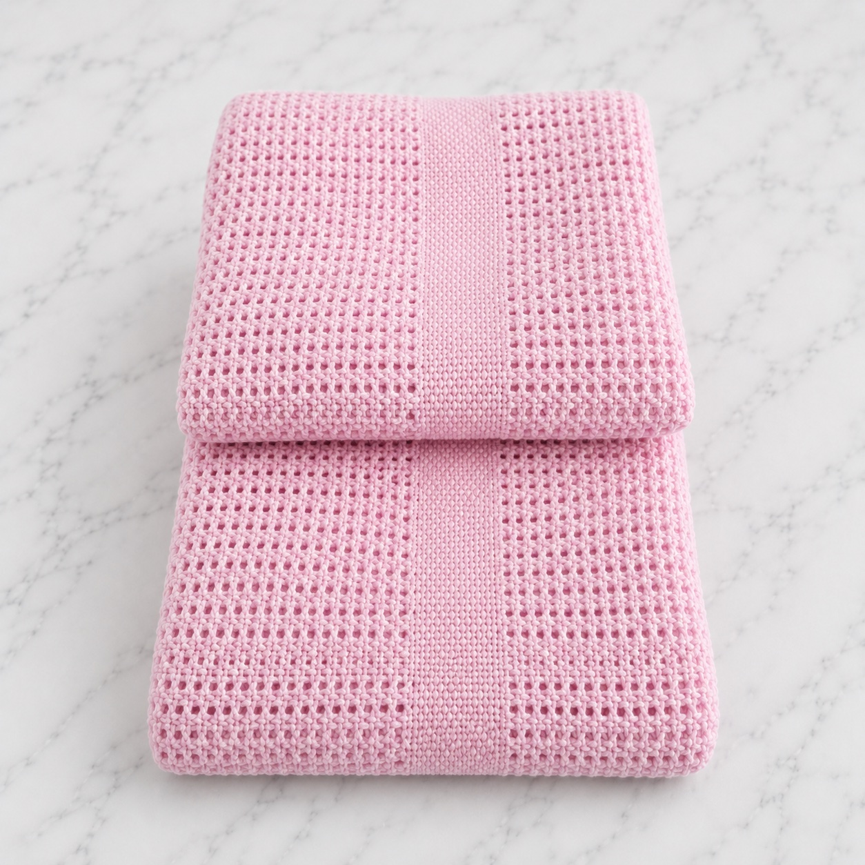 Soft pink cellular pram blanket included in the nappy cake