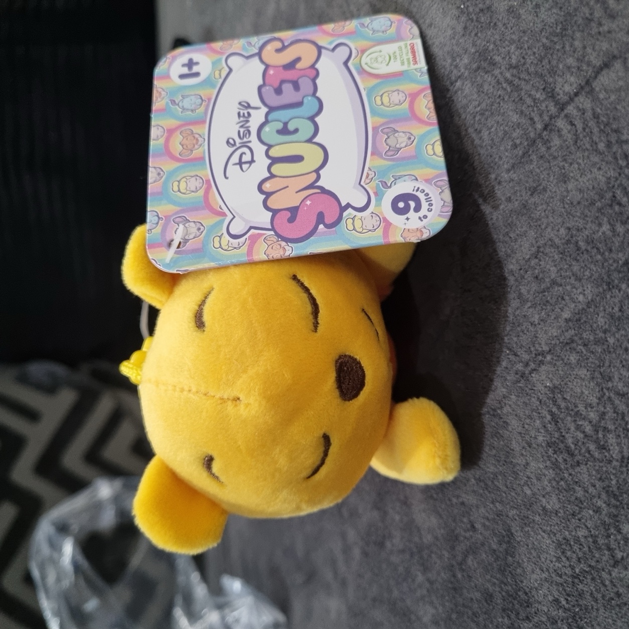 Winnie the Pooh Snuglet with its Disney Snuglets gift tag, suitable for ages 1 and up